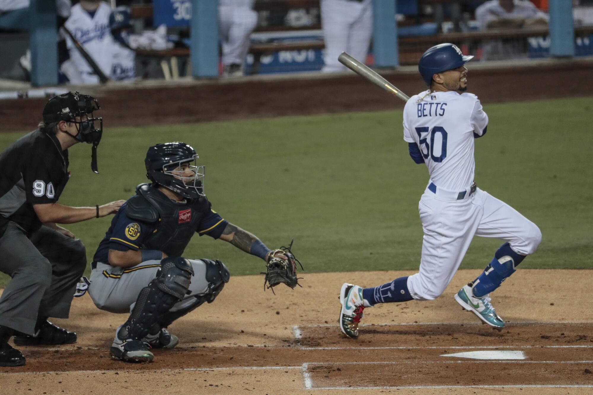 Dodgers right fielder Mookie Betts doubles in the first inning against the Milwaukee Brewers.