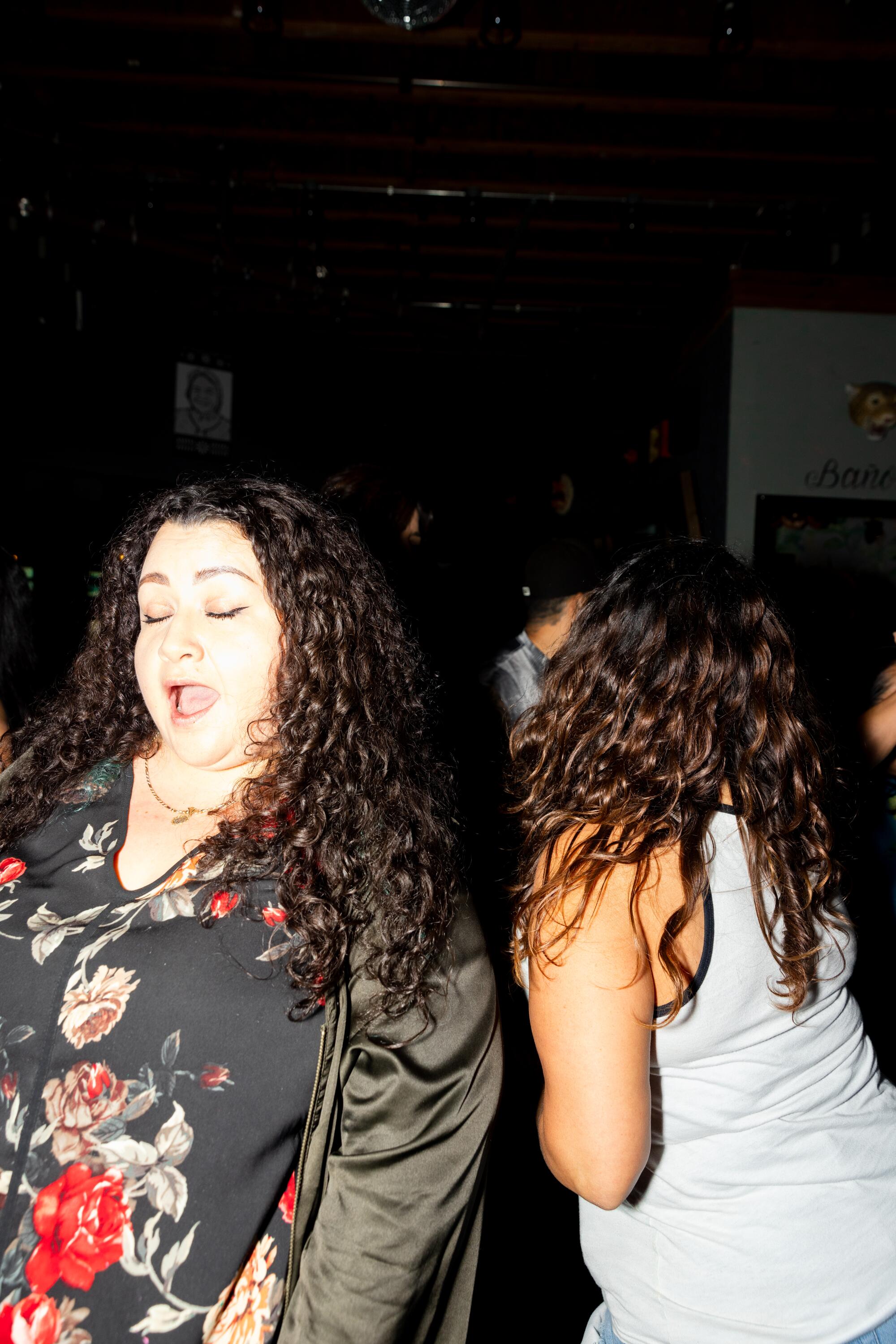 Dancers sing along to cumbia music at Toxica Fridays at Mi Corazón.