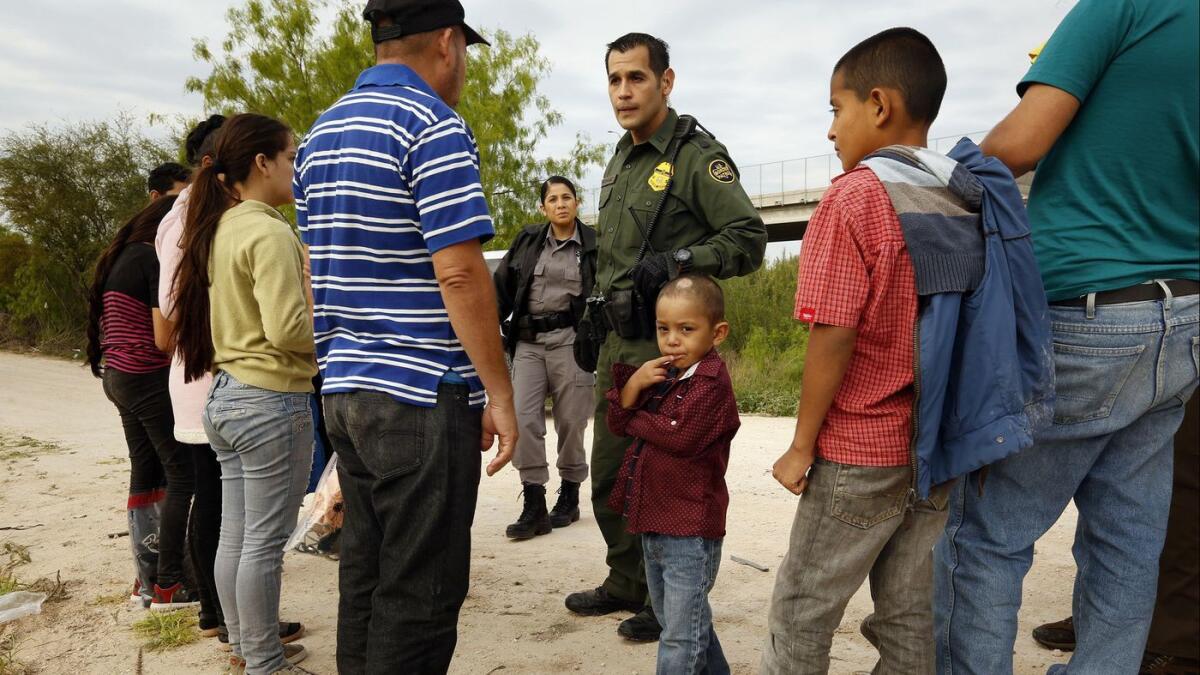 Ely Fernandez of Honduras is questioned after being detained for crossing the border illegally in March with his 5-year-old son, Bryan.