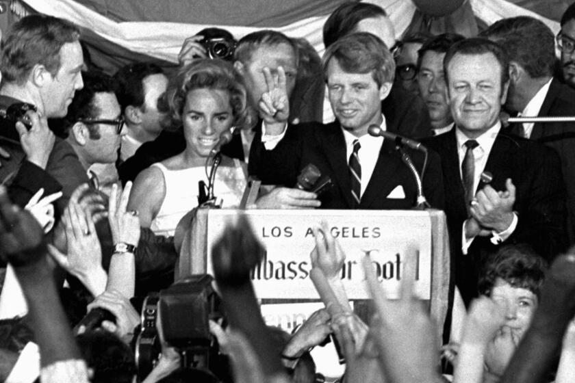 FILE - This June 5, 1968 file photo shows Sen. Robert F. Kennedy speaking his final words to supporters at the Ambassador Hotel in Los Angeles, moments before he was shot on June 5, 1968. At his side are his wife, Ethel, left, and his California campaign manager, Jesse Unruh, right. Football player Roosevelt Grier is at right rear. Associated Press Hollywood reporter Bob Thomas was on a one-night political assignment in June 1968 to cover Kennedyâs victory in the California presidential primary when mayhem unfolded before his eyes. (AP Photo/Dick Strobel, File)