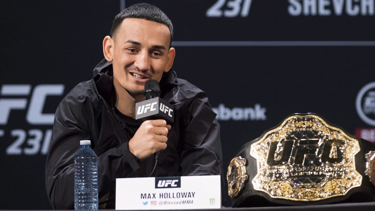 UFC featherweight champion Max Holloway speaks at a news conference Dec. 5 in Toronto.