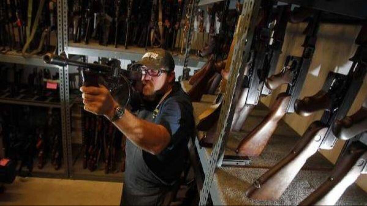Technician Brian Rogers checks on the inventory of Thompson submachine guns at the Independent Studio Services prop warehouse in Sunland.