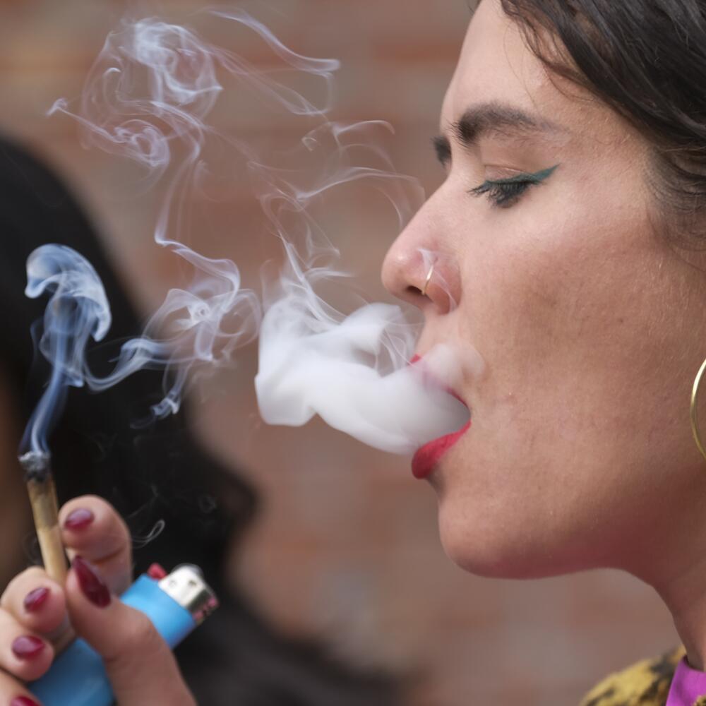 A woman blowing smoke