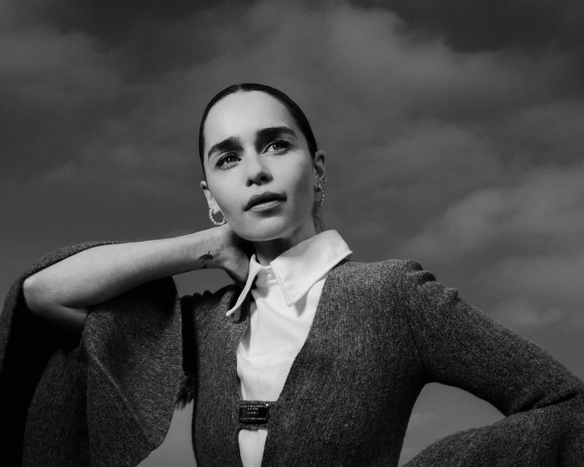A black and white portrait of Emilia Clarke