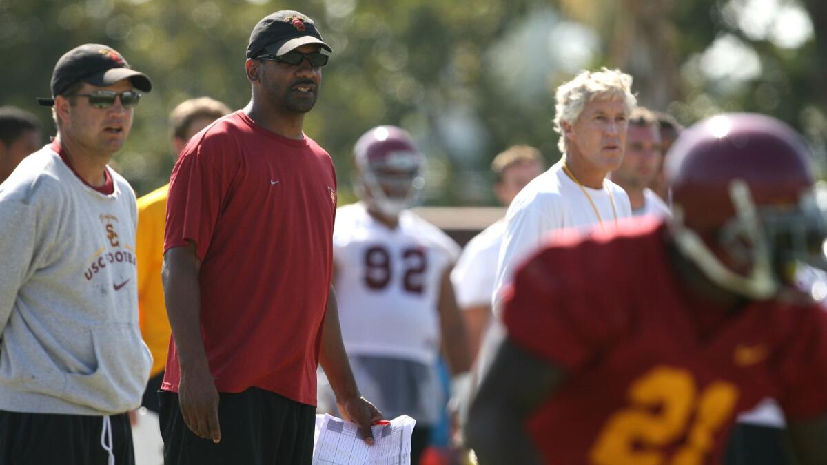 Former USC Trojans tailback coach Todd McNair watches USC team scrimmage with former head coach Pete Carroll.