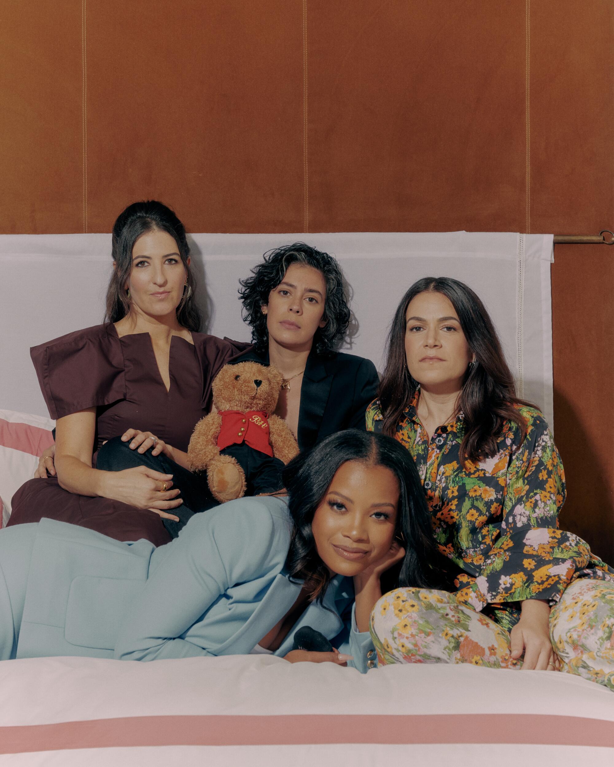 Four women on a bed