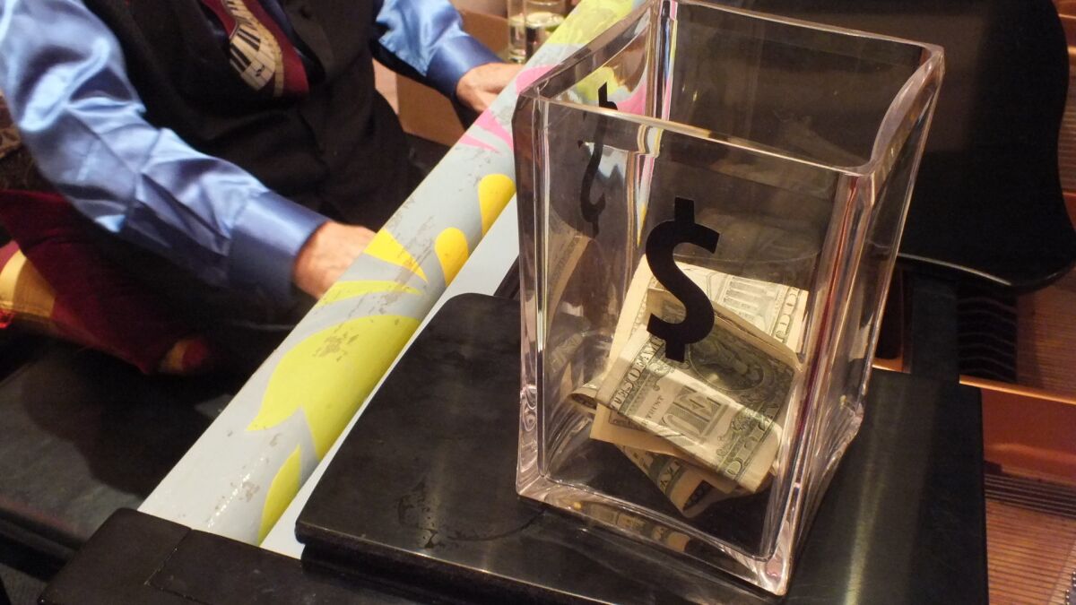 As Joe Vento plays requests on a Steinway piano, a tip jar slowly fills with money.