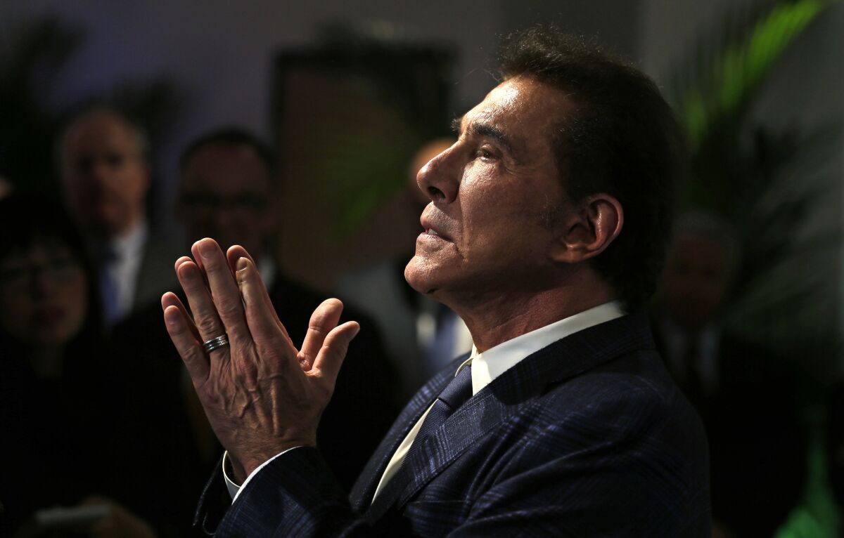 Steve Wynn holds his hands together