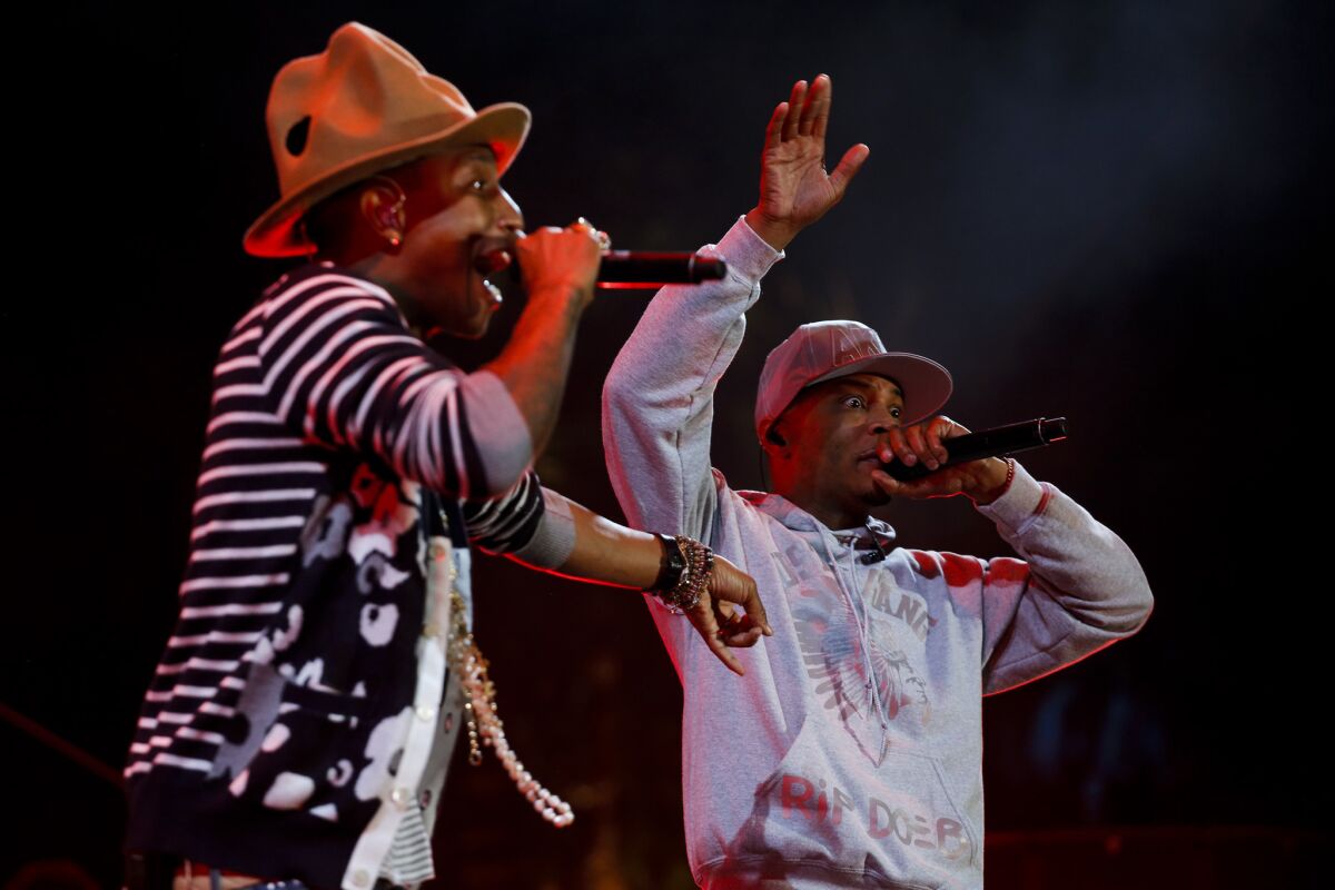 Pharrell Williams, left, performs with rapper T.I. on the second day of the second weekend of the Coachella Valley Music and Arts Festival at the Empire Polo Club in Indio on April 19, 2014.