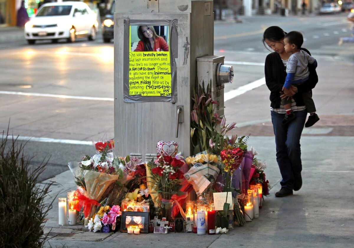 Nga Doan, right, of Fountain Valley and her 21-month-old son, Frederik Doan, say goodbye to their niece and cousin, Kim Pham, 23, at a memorial outside The Crosby nightclub in downtown Santa Ana.