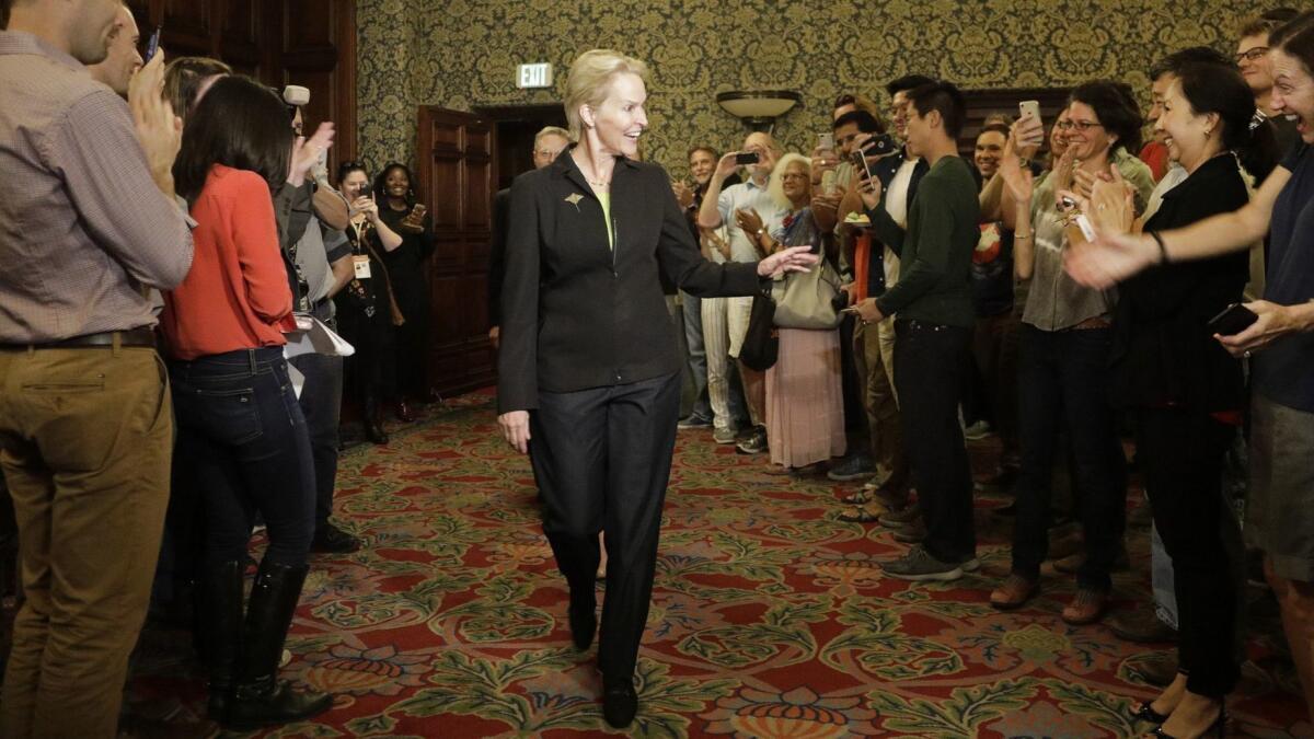 Frances Arnold receives a standing ovation during a celebration at Caltech for her Nobel Prize.