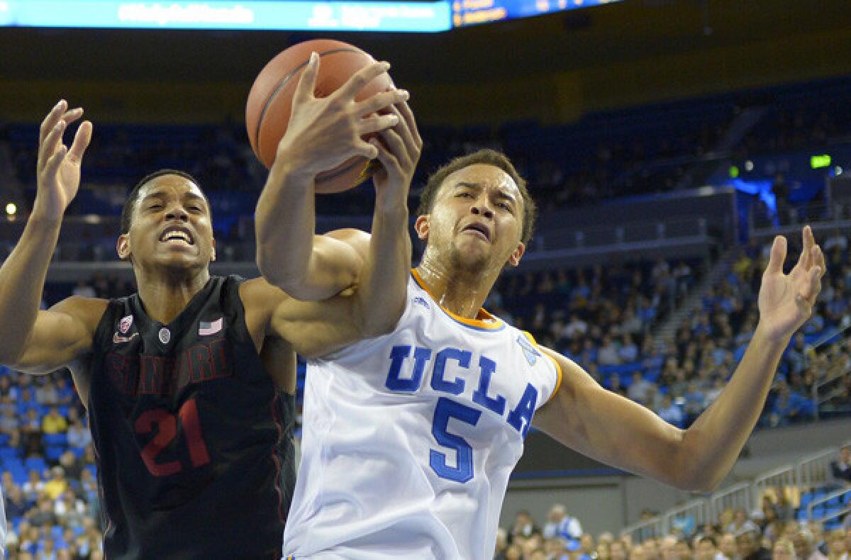 UCLA guard Kyle Anderson battles Stanford forward Anthony Brown for a rebound in a game Wednesday night at Pauley Pavilion.