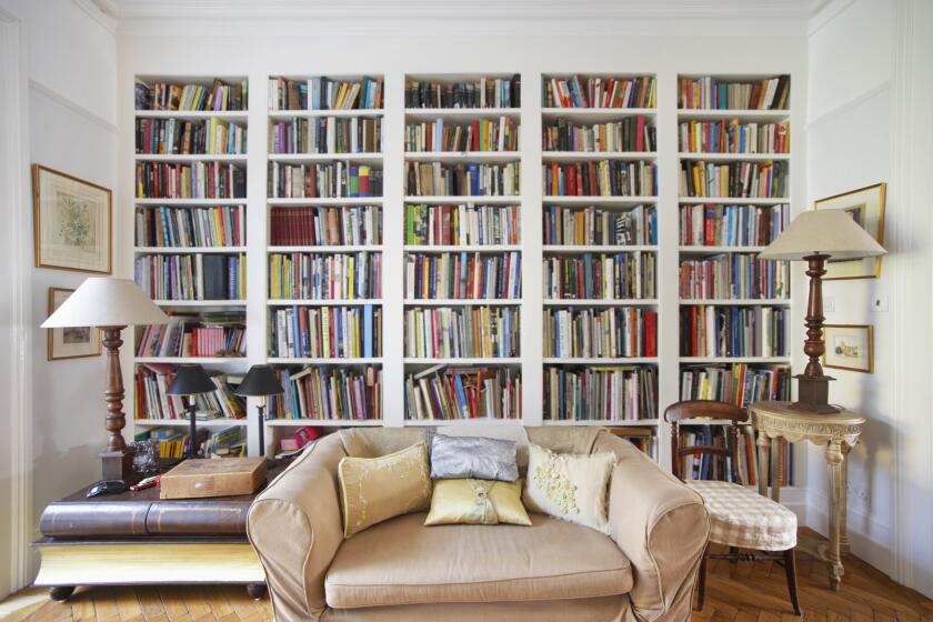 A living room with a wall of books.
