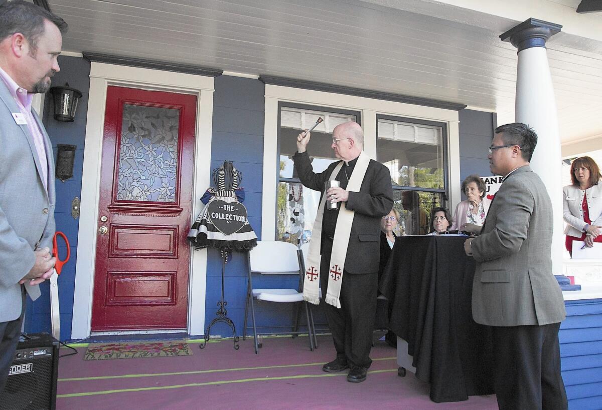 Bishop Kevin Vann blesses the new resale boutique store, The Collection, a store that benefits the non-profit Casa Teresa, on the organizations 40th anniversary on Monday. Based in Orange and founded by Sandy Sullivan, the Casa Teresa has served over 6,000 mothers since 1976 in Orange County.
