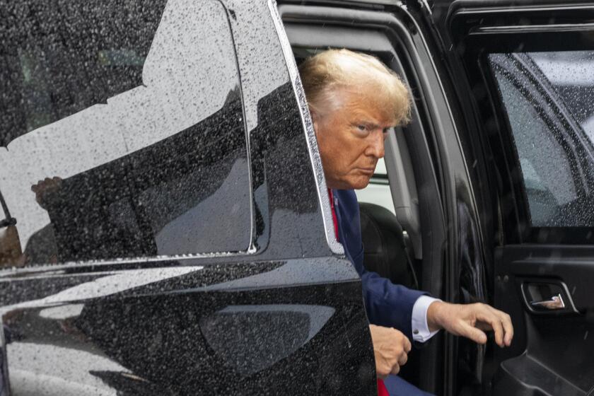 Former President Donald Trump exits his vehicle to walk over to speak with reporters before he boards his plane at Ronald Reagan Washington National Airport, Thursday, Aug. 3, 2023, in Arlington, Va., after facing a judge on federal conspiracy charges that allege he conspired to subvert the 2020 election. (AP Photo/Alex Brandon)