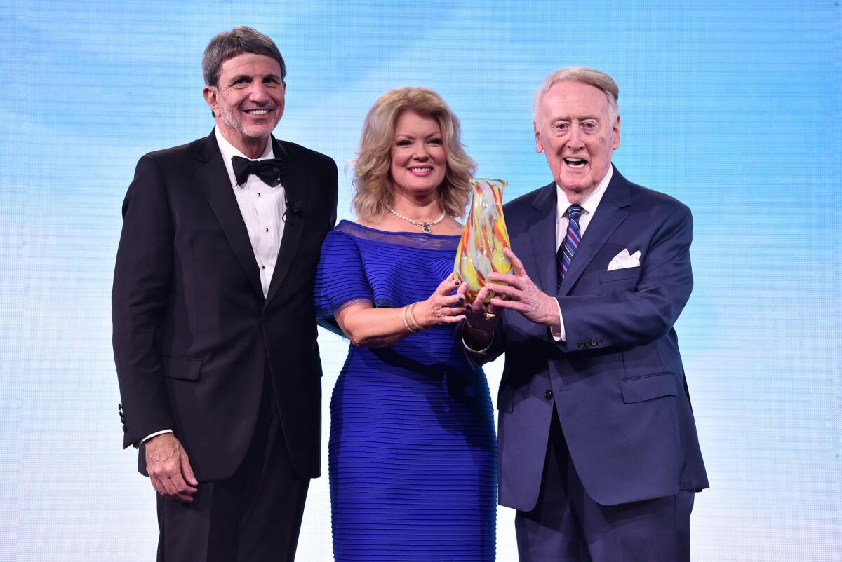 Hospital Chief Executive Paul Viviano, left, and hospital trustee Mary Hart present a Courage to Care Award to Vin Scully at the Children's Hospital Los Angeles gala.