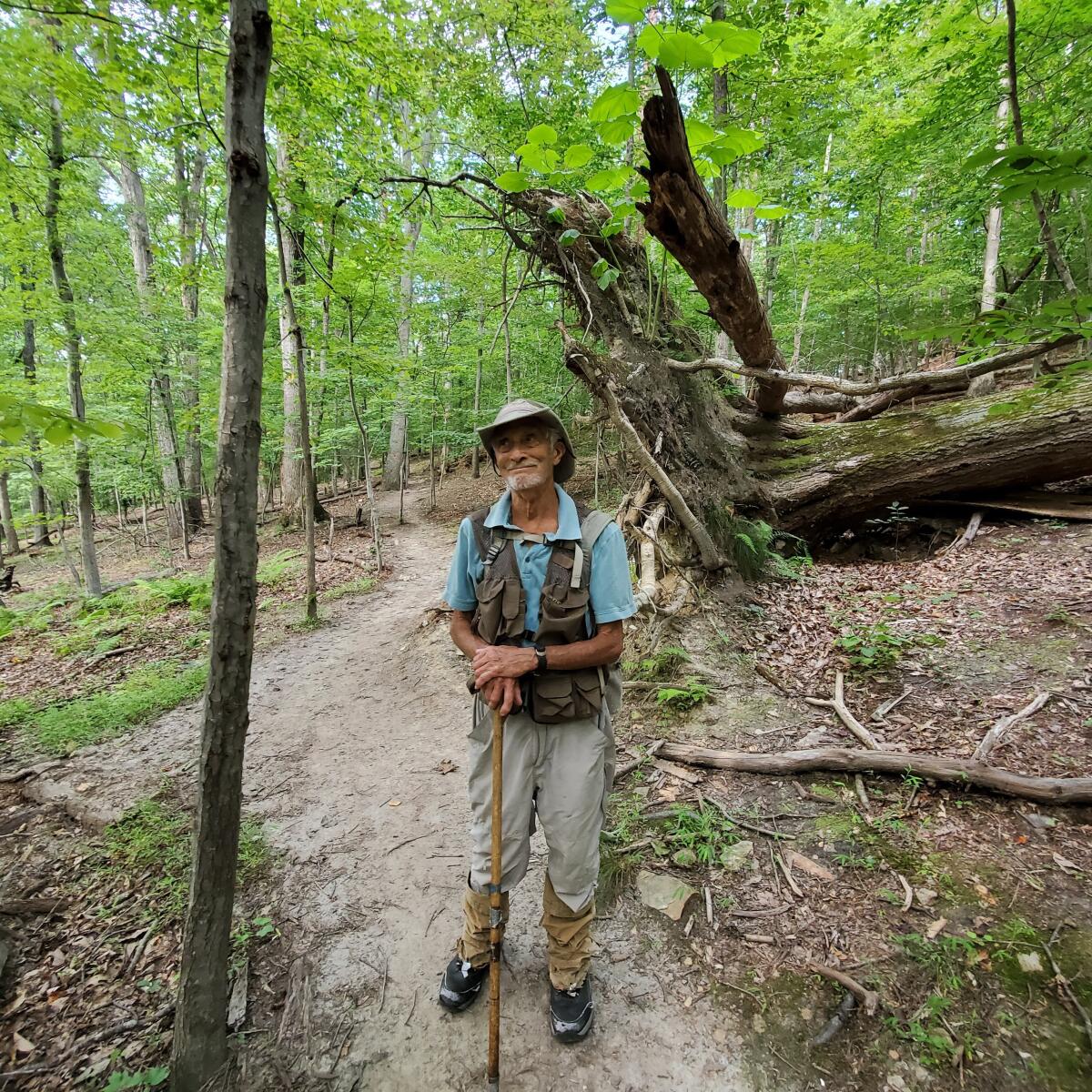 In this photo provided by Joe Villari, with the Virginia Outdoors Foundation, William H. “Marty” Martin poses for a picture at the Bull Run Mountains Preserve in Broad Run, Va., in July 2021. Martin, a respected snake researcher who had been making significant discoveries about the species since childhood, died Aug. 3, 2022, after being bitten the day before by a timber rattler. (Joe Villari/Virginia Outdoors Foundation via AP)