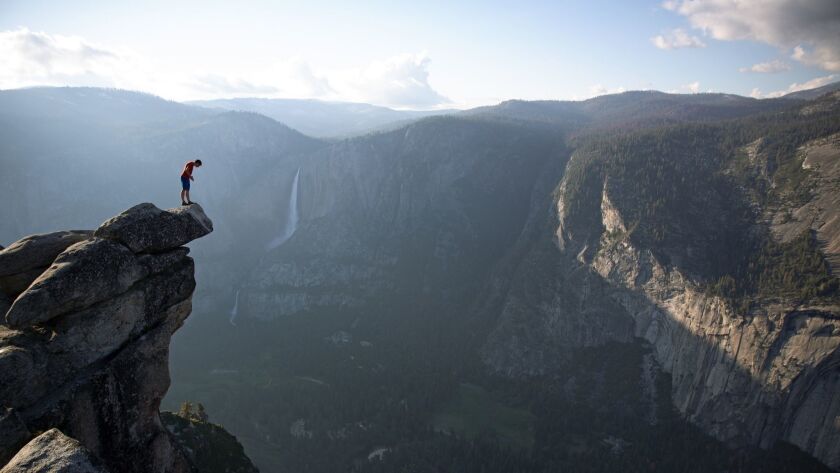 Climber Alex Honnold peers over the edge of Glacier Point in Yosemite National Park. He had just climbed 2,000 feet up from the valley floor.