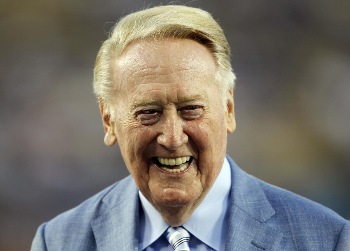 Los Angeles Dodgers broadcaster Vin Scully is honored before a baseball game. Scully was given a Guinness World Records certificate for the longest career as a sports broadcaster for a single team.