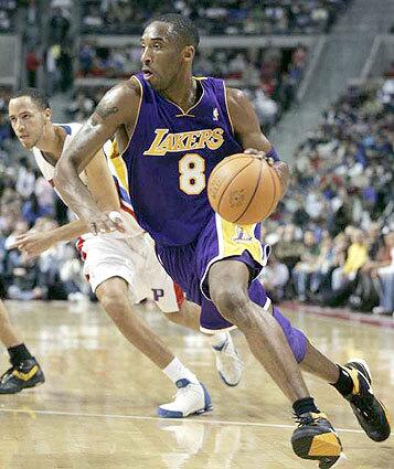 GOING THIS WAY: Kobe Bryant leaves Piston forward Tayshaun Prince behind as he spins to the basket.