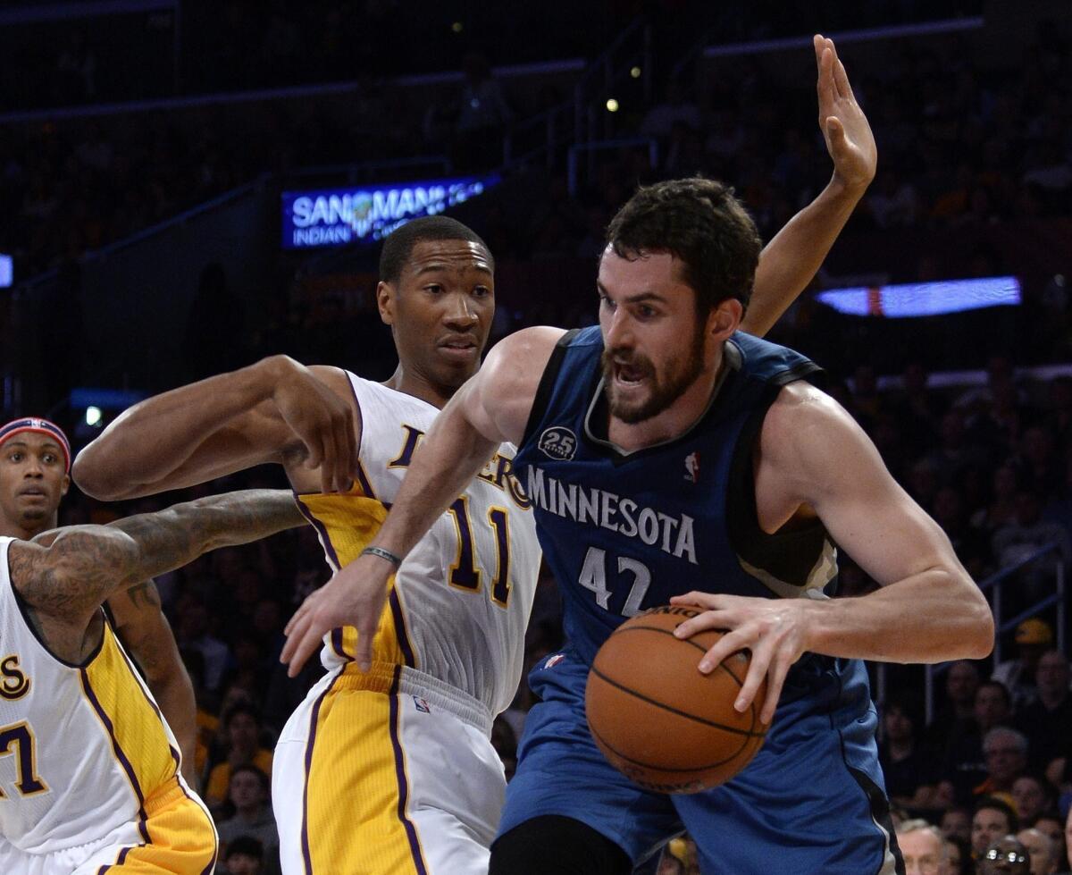 Minnesota Timberwolves forward Kevin Love, right, drives inside on Lakers forward Wesley Johnson during a November game at Staples Center. The Lakers play on the road at Minnesota on Tuesday.