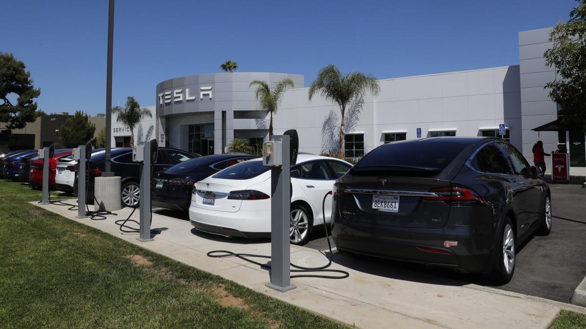 A Tesla service facility in Costa Mesa. Tesla recently passed the 200,000-car sales threshold under which it starts losing a $7,500 federal tax credit on electric vehicles.