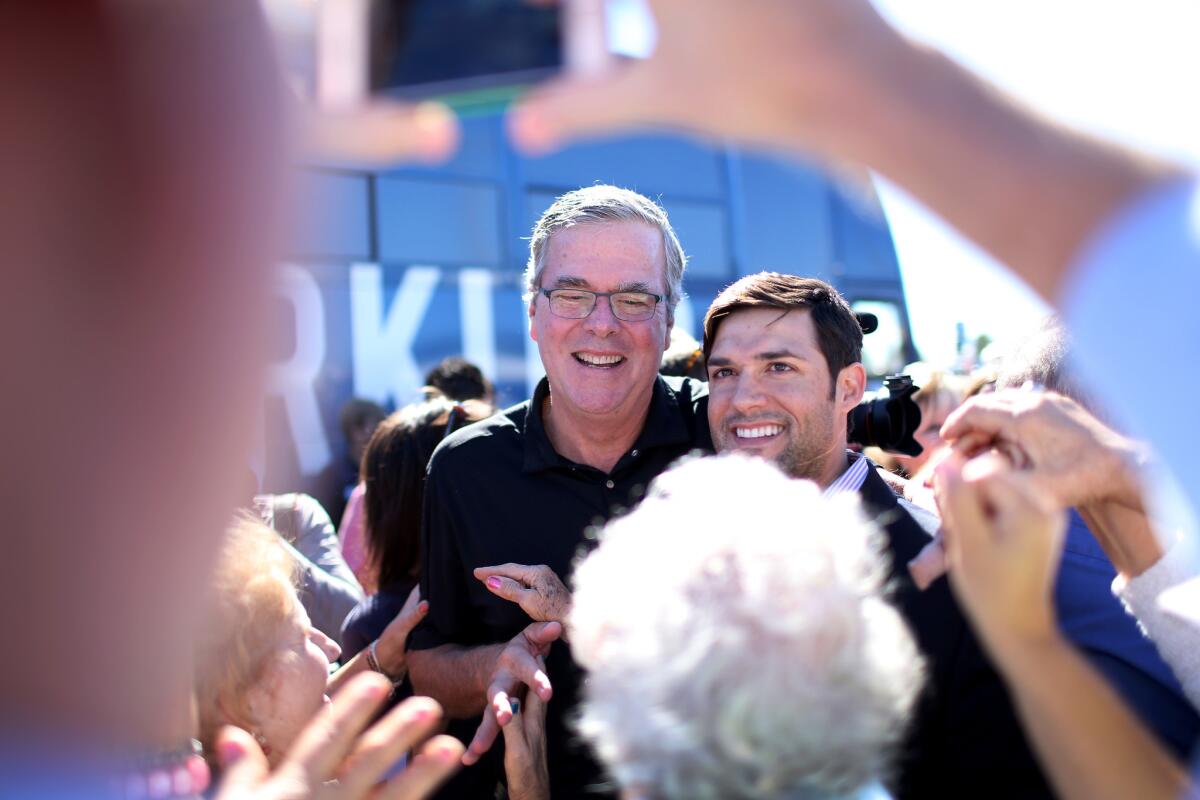 Former Florida Governor Jeb Bush (left) campaigns with Florida Governor Rick Scott during a stop at Milander Park on November 2, 2014 in Hialeah, Florida.