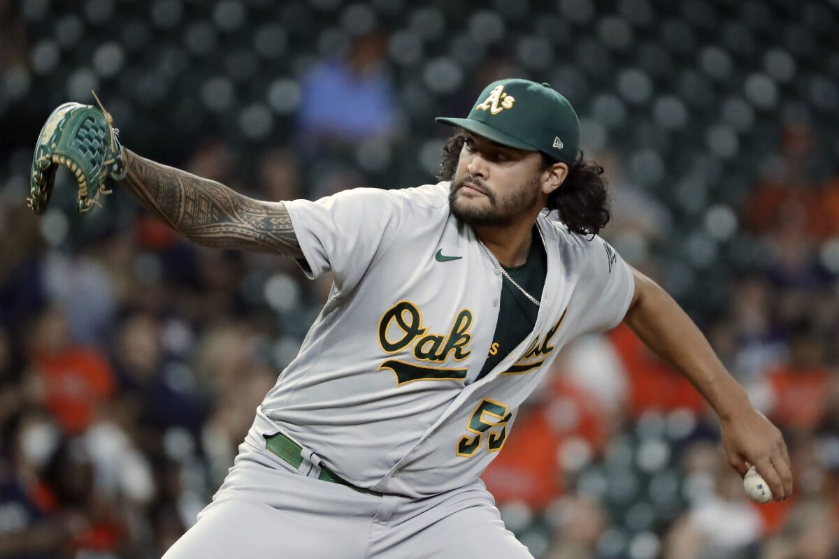 FILE - Oakland Athletics starting pitcher Sean Manaea throws against the Houston Astros during the first inning of a baseball game, Oct. 1, 2021, in Houston. The San Diego Padres bolstered their rotation on Sunday, April 3, 2022, acquiring left-hander Manaea in a trade with the Athletics. (AP Photo/Michael Wyke, File)
