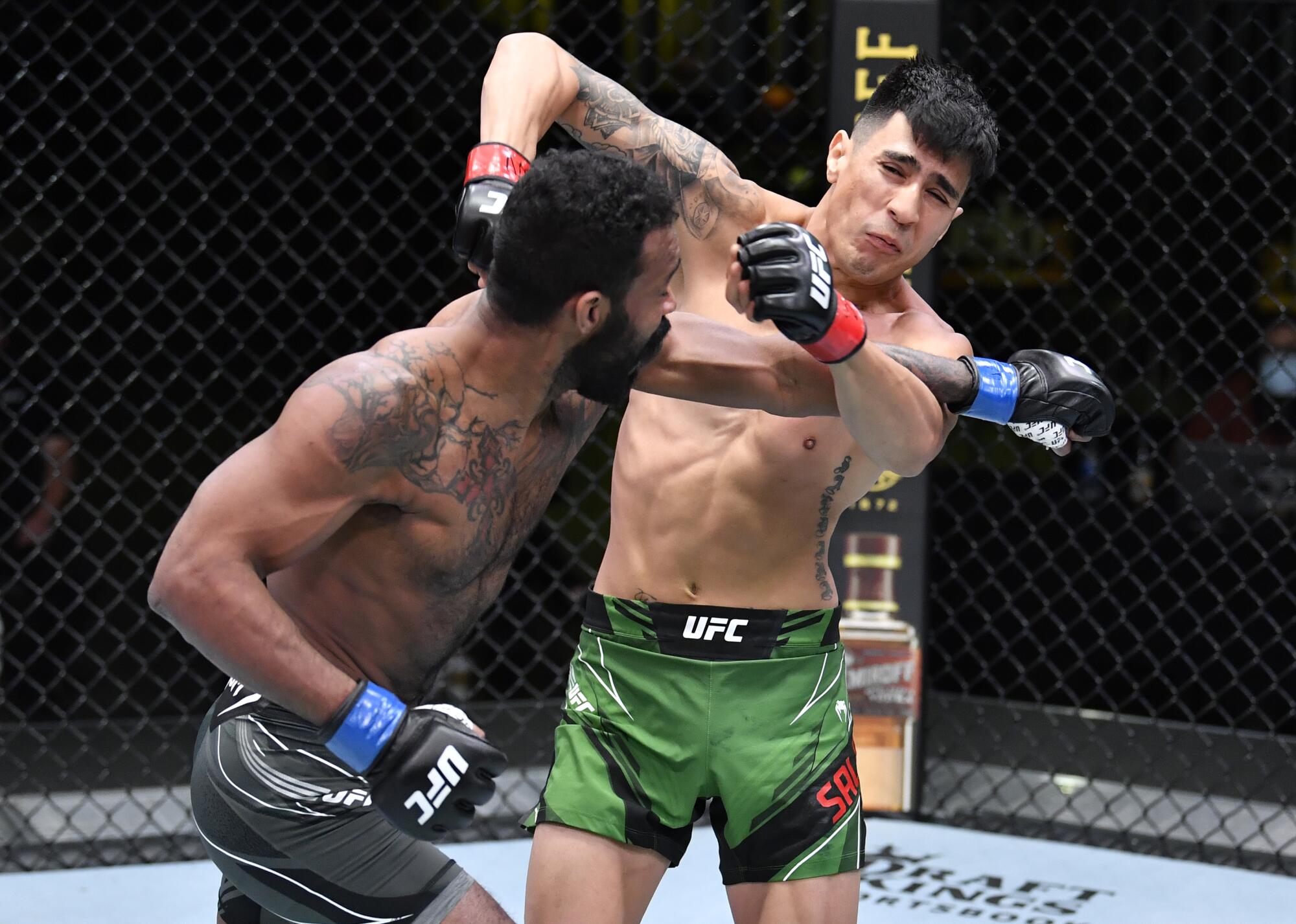 LAS VEGAS, NEVADA - APRIL 10: (L-R) Jordan Griffin punches Luis Saldana.