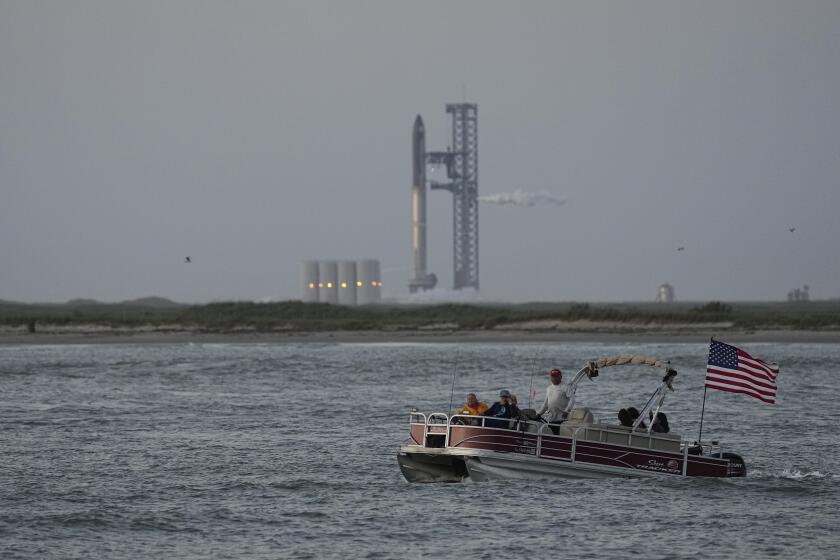 A boater passes SpaceX's Starship, the world's biggest and most powerful rocket, as it prepares to lift off from Starbase in Boca Chica, Texas,, Monday, April 17, 2023. (AP Photo/Eric Gay)