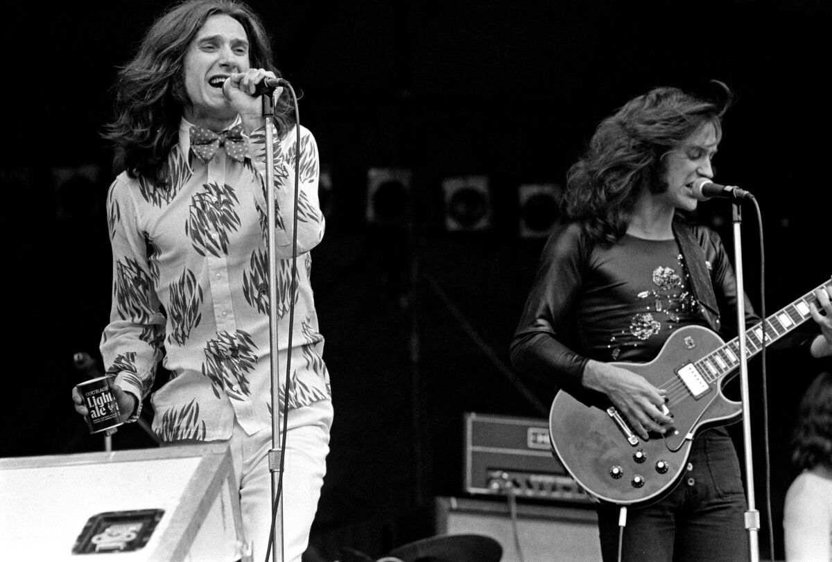 Two long-haired brothers perform in a rock band in the 1970s