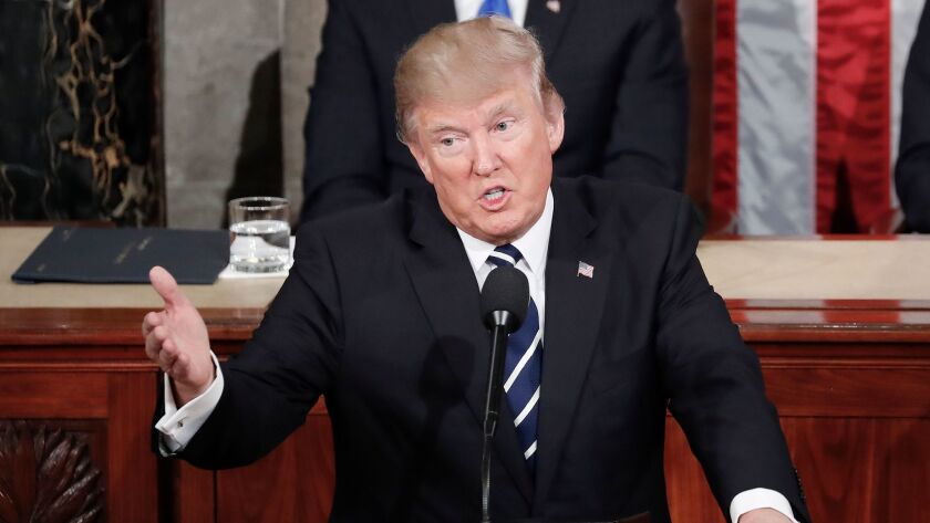 President Trump gestures toward democrats while addressing a joint session of Congress on Capitol Hill in Washington on Feb. 28.
