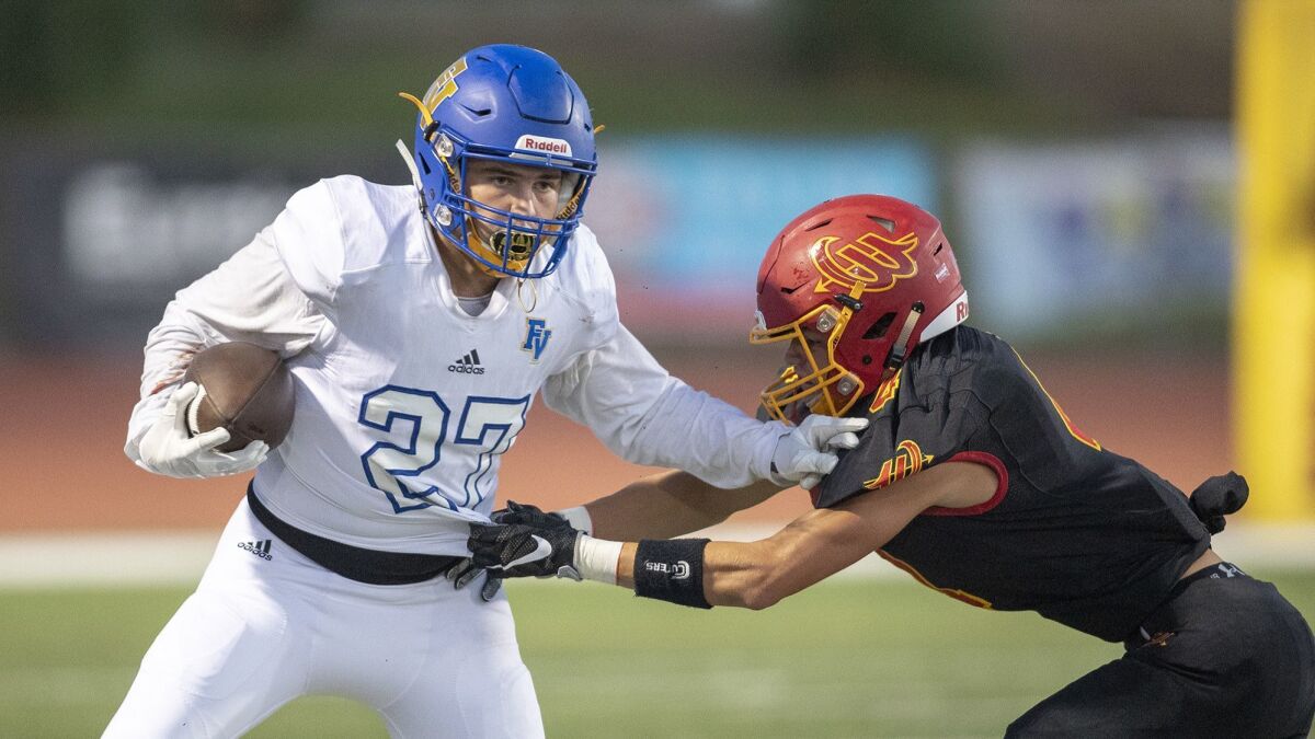Fountain Valley High's Brandon Krause, shown stiff-arming a Woodbridge defender on Aug. 31, had three touchdown catches in a 50-0 win at Long Beach Rancho Dominguez on Friday.