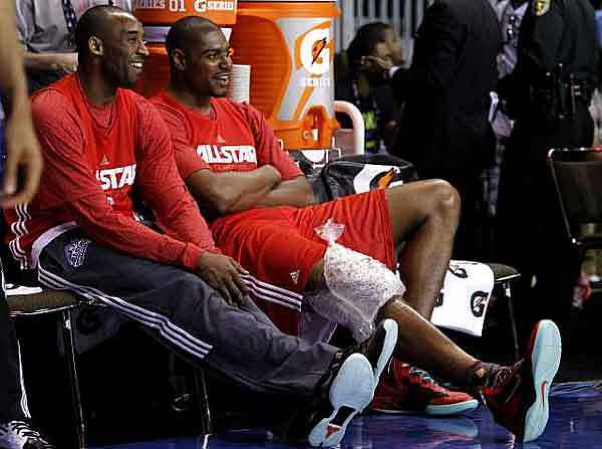 Lakers stars Kobe Bryant and Andrew Bynum share a laugh during a break at All-Star practice on Saturday in Orlando.