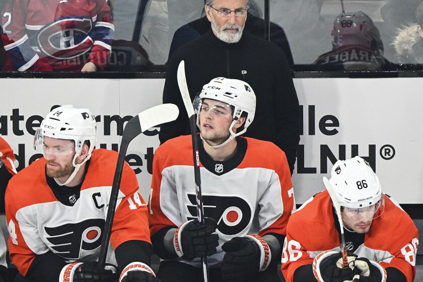 Philadelphia Flyers head coach John Tortorella looks on from the bench during the first period of an NHL hockey game against the Montreal Canadiens in Montreal, Tuesday, April 9, 2024. (Graham Hughes/The Canadian Press via AP)