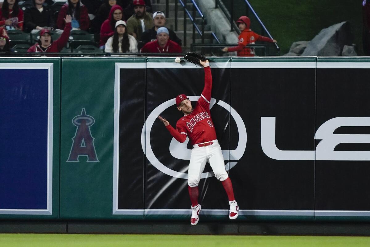 Angels left fielder Taylor Ward can't come up with the catch on a double hit by Minnesota's Edouard Julien.