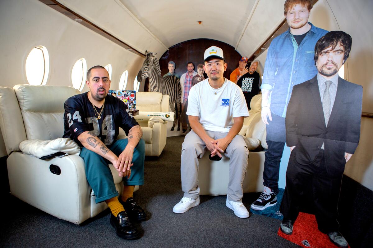 Nick Santiago and Matthew Hwang, founders of Pizzaslime, on a set built to look like the inside of a private jet. 