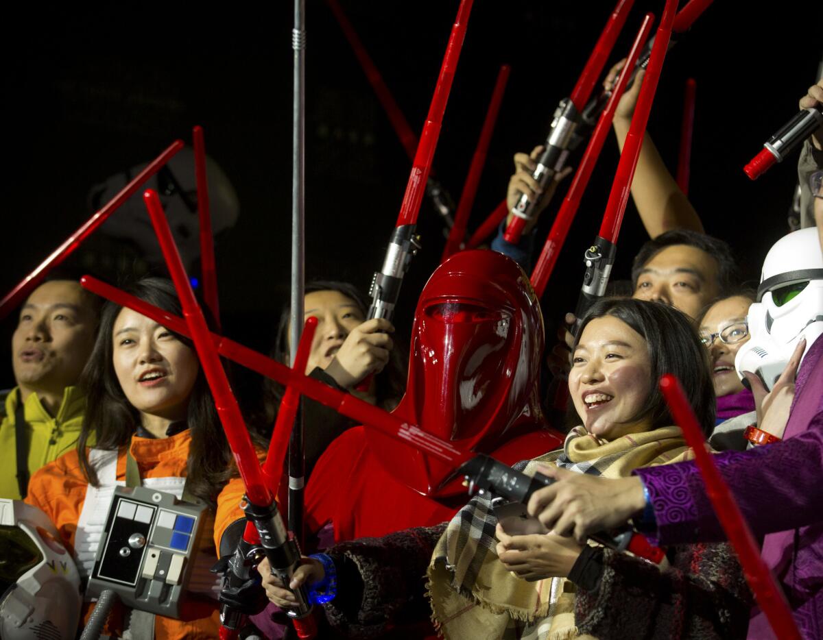 Chinese Star Wars fans pose with light sabers during a promotional event for "Star Wars: The Force Awakens" at the Great Wall of China near Beijing in October 2015.