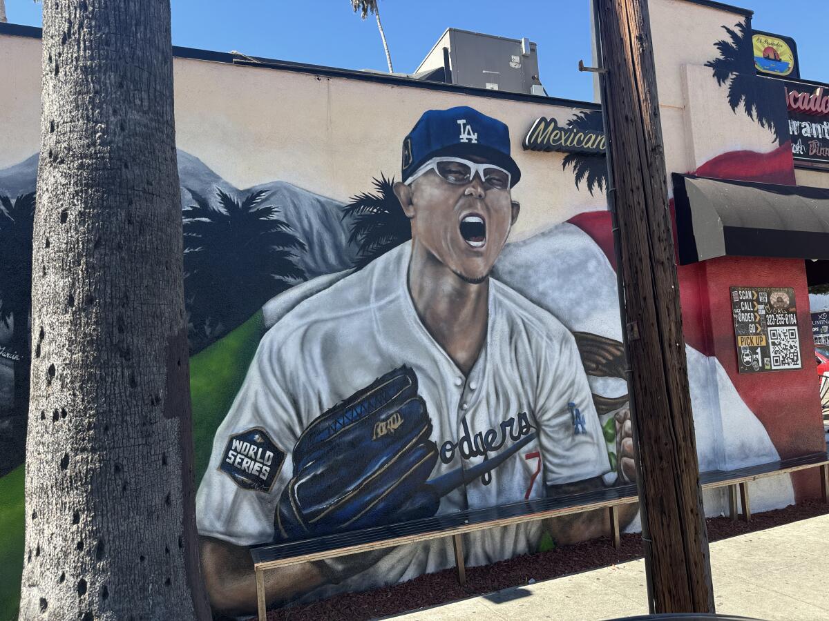 A mural that features Julio Urías and Kobe Bryant remains on a wall of El Pescador, a Mexican restaurant in Highland Park.