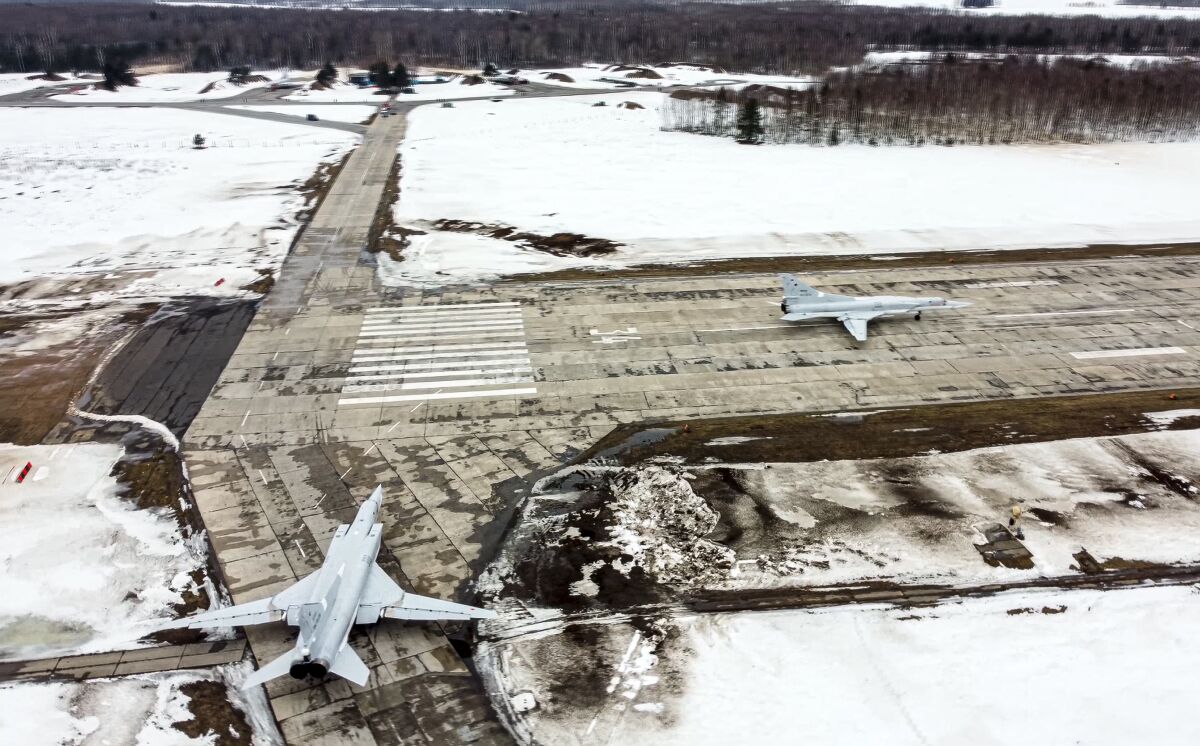 In this photo taken from video and released by the Russian Defense Ministry Press Service on Saturday, Feb. 5, 2022, A pair of Tu-22M3 bombers of the Russian air force taxi before takeoff at an air base in Russia. Two Tu-22M3 long-range bombers of the Russian air force performed a patrol mission over Belarus on Saturday amid the tensions over Ukraine. (Russian Defense Ministry Press Service via AP)