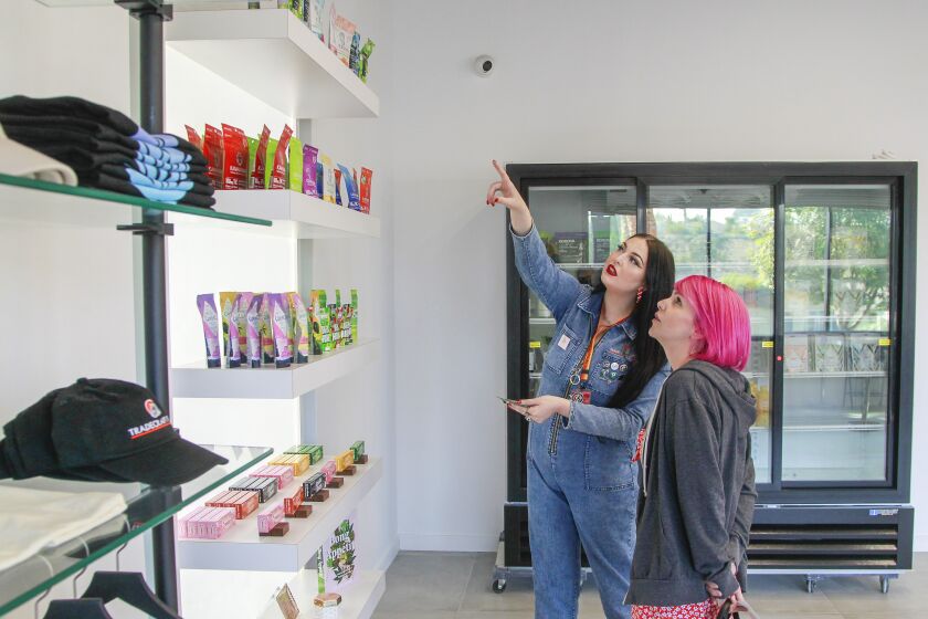 Bud tender Shelby Fischer (left) explains some of the marijuana products to customer Krystle Paniagua at Tradecraft Farms on November 6, 2019 in Vista, California.