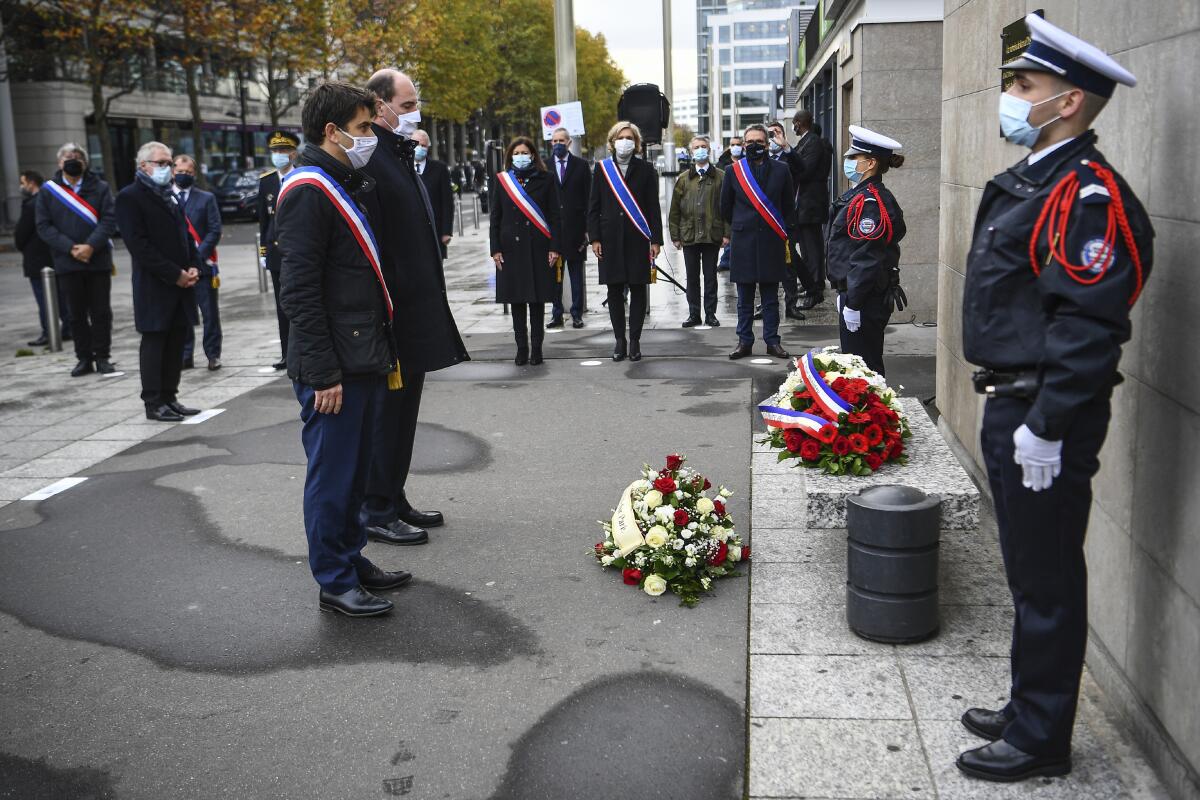Saint-Denis Mayor Mathieu Hanotin, left, and French Prime Minister Jean Castex participate in a wreath-laying ceremony