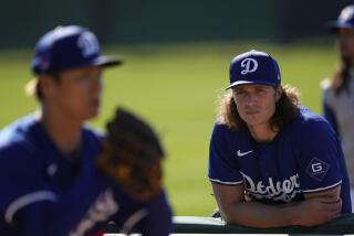 Los Angeles Dodgers pitcher Tyler Glasnow, right, watches as teammate Yoshinobu Yamamoto.