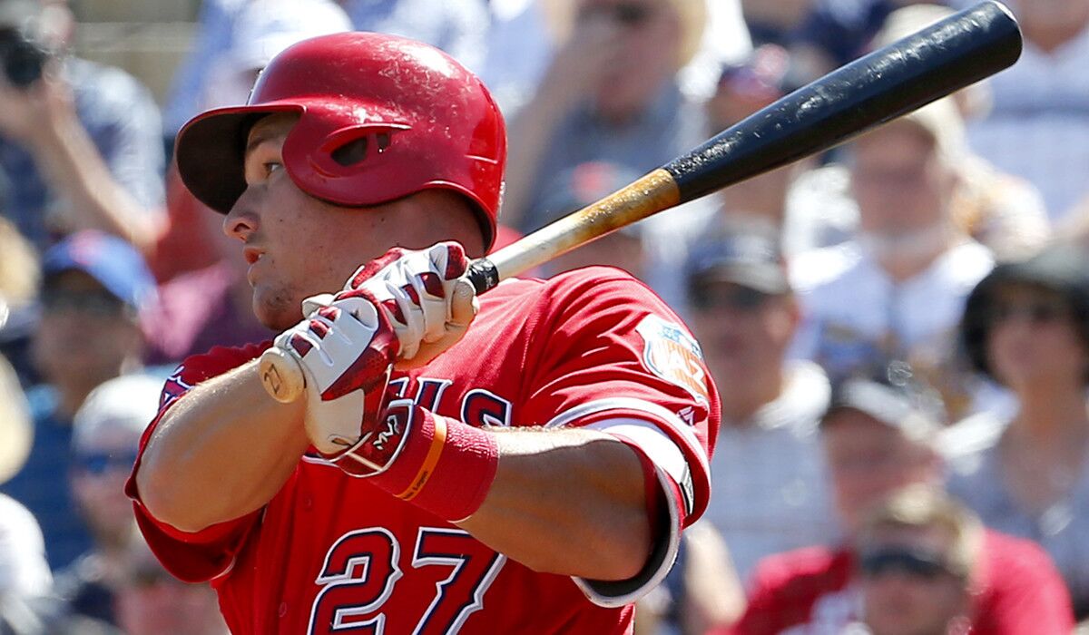 Los Angeles Angels' Mike Trout follows through on a base hit during the first inning of a spring training baseball game against the Cleveland Indians on Wednesday in Goodyear, Ariz.