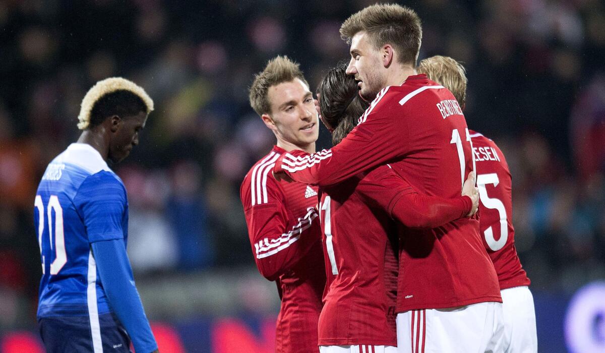 Nicklas Bendtne, center, is congratulated by Denmark teammates after scoring one of his three goals against the U.S. on Wednesday night.