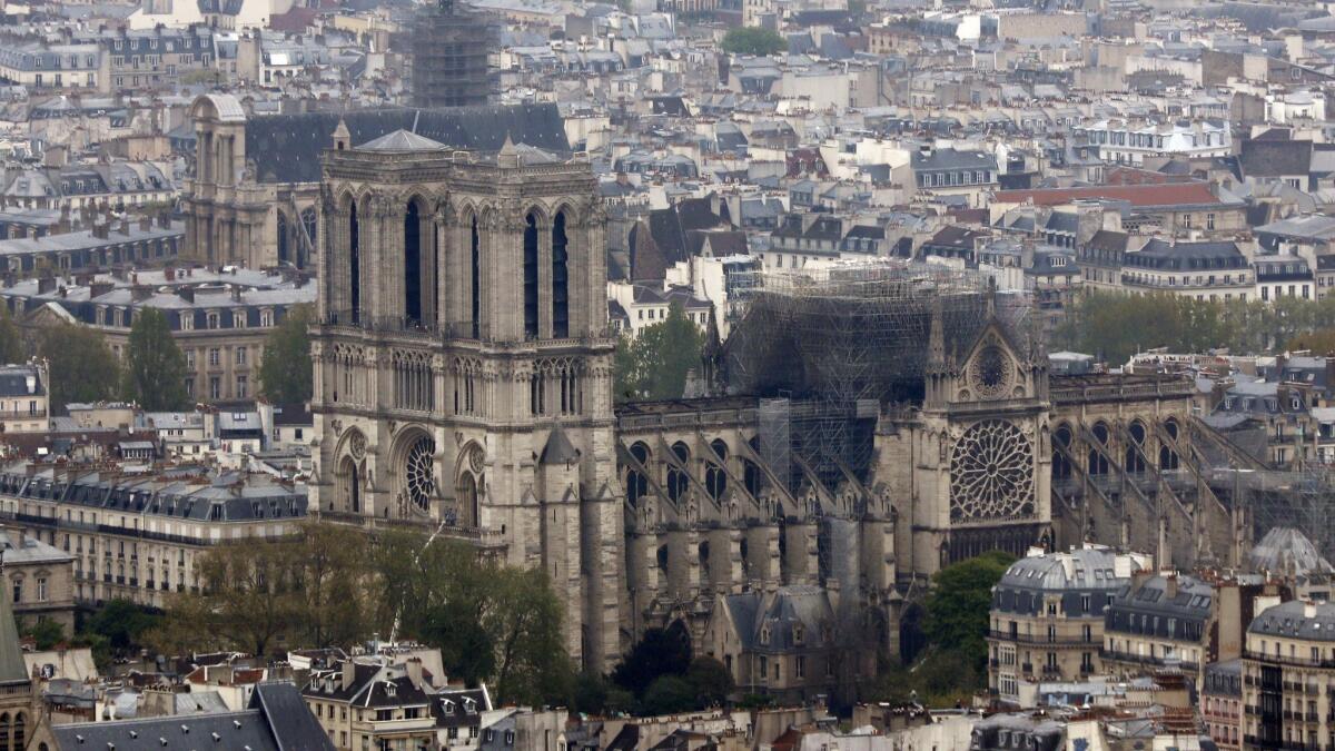 Firefighters declared success Tuesday morning in a 12-hour-plus battle to extinguish an inferno engulfing Paris' iconic Notre Dame Cathedral that claimed its spire and roof but spared its bell towers.