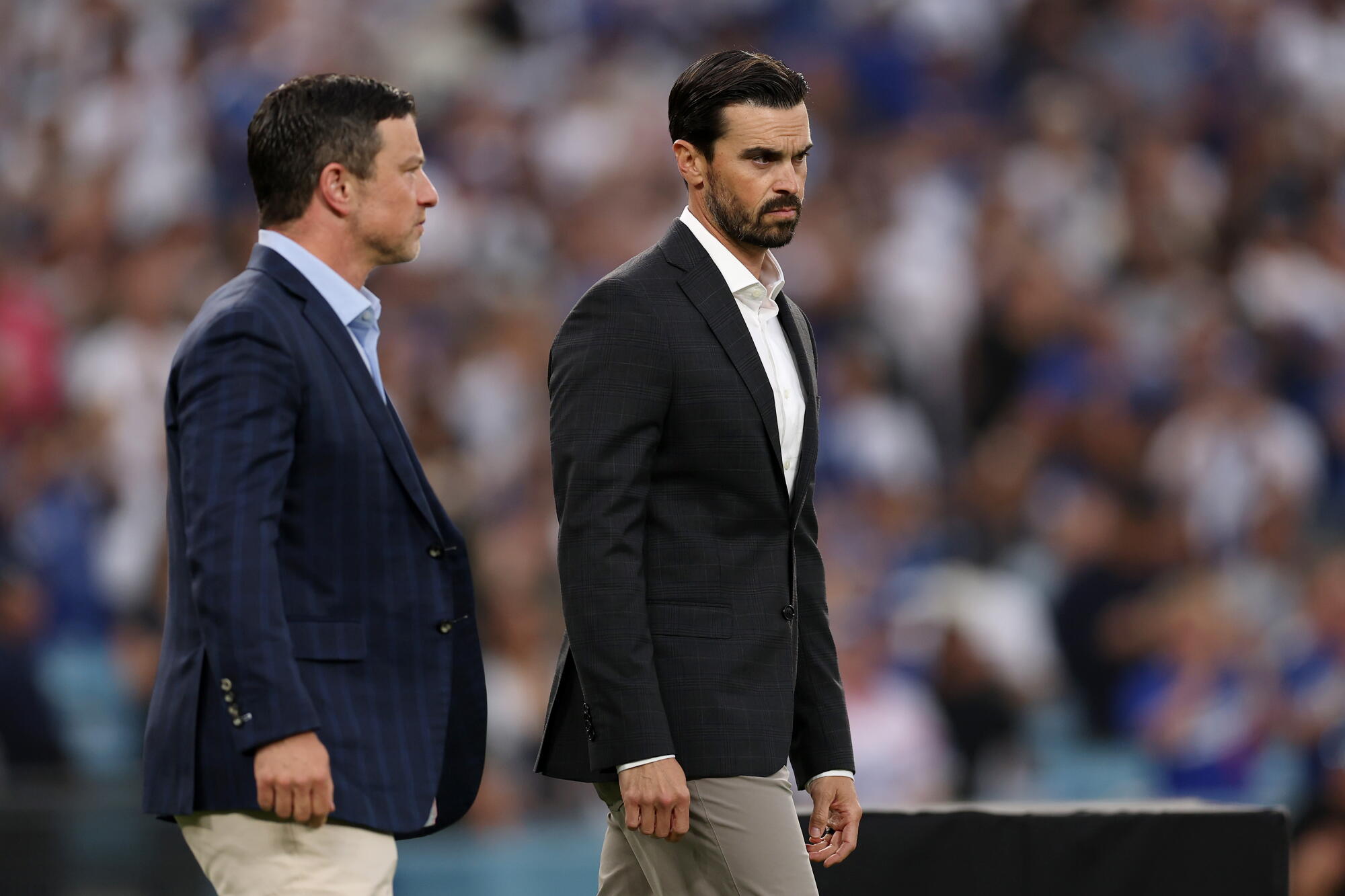 Dodgers president of shot operations Andrew Friedman, left, and wide head Brandon Gomes look connected earlier a game.