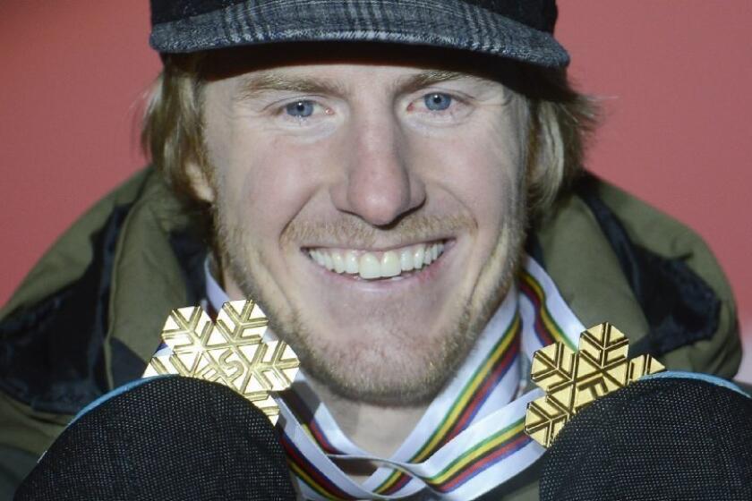 Ted Ligety holds up the two gold medals he has won at this year's world championships.