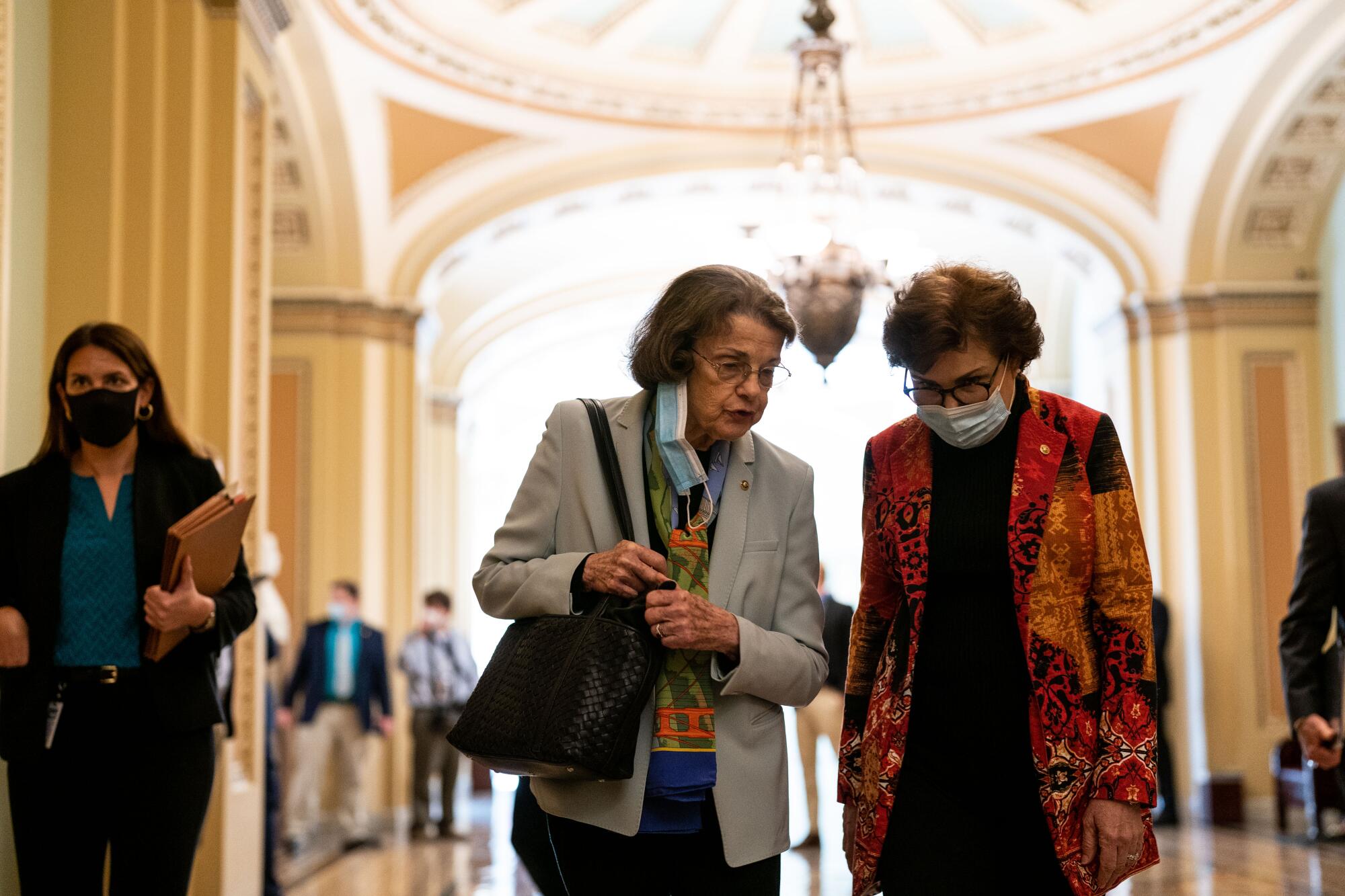 Dianne Feinstein and Jacky Rosen walk together in the Capitol. 