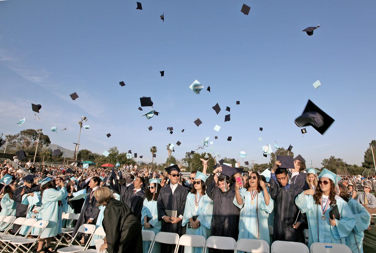 Graduates throw their mortarboards in the air at the conclusion of the Crescenta Valley High School graduation ceremony on Wednesday, June 1, 2016.